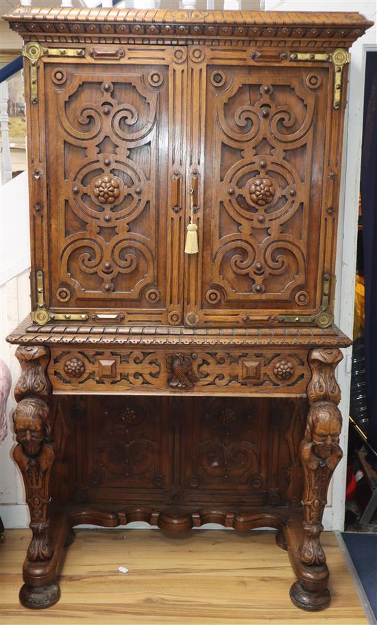 A mid 19th century carved oak cabinet on stand, in the manner of Richard Bridgens, W.187cm